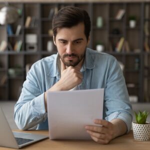 img of a man reading papers