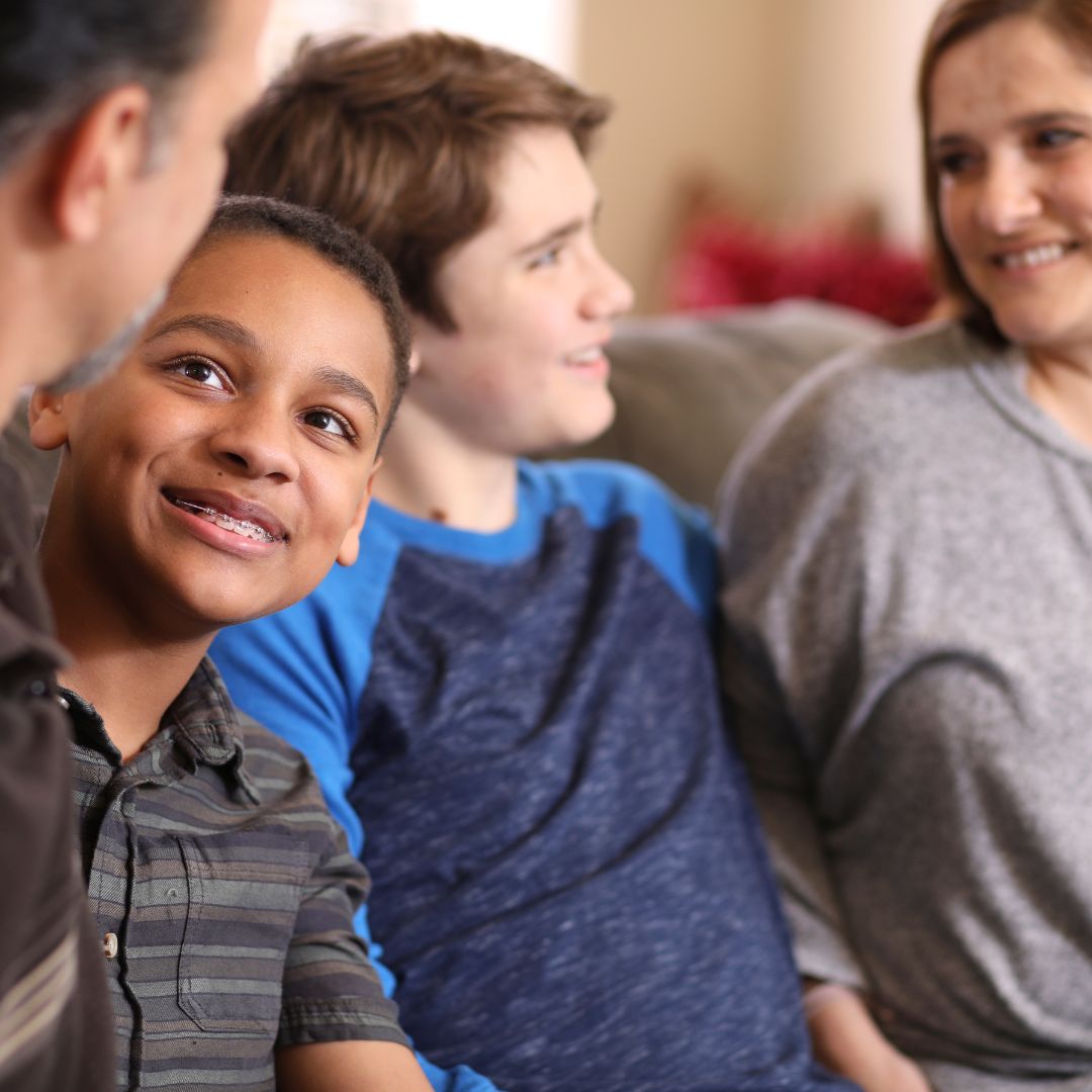 family sitting together on couch