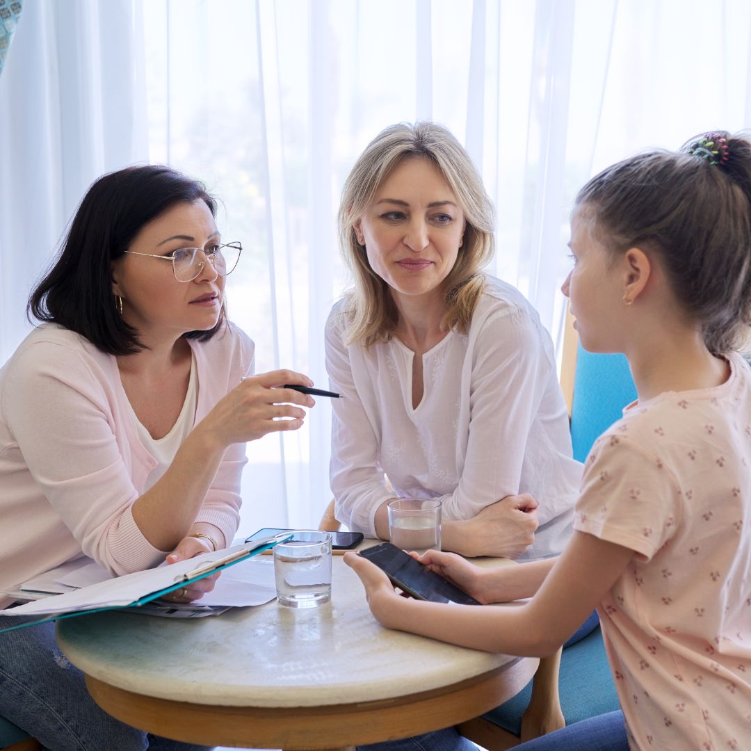 foster parent and child speaking with professional